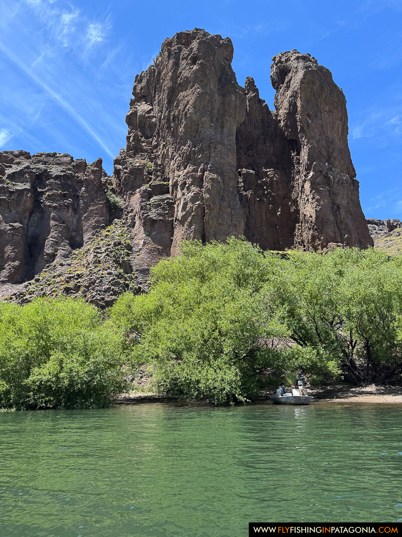 Anglers drifting beneath dramatic cliffs on the Alumine River
