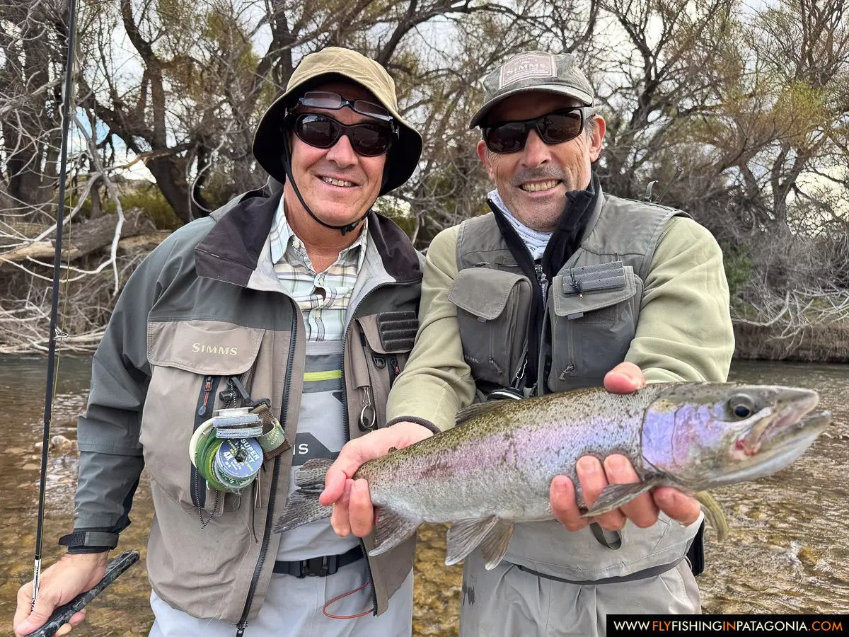 Two anglers holding a rainbow trout from the Collon Cura River