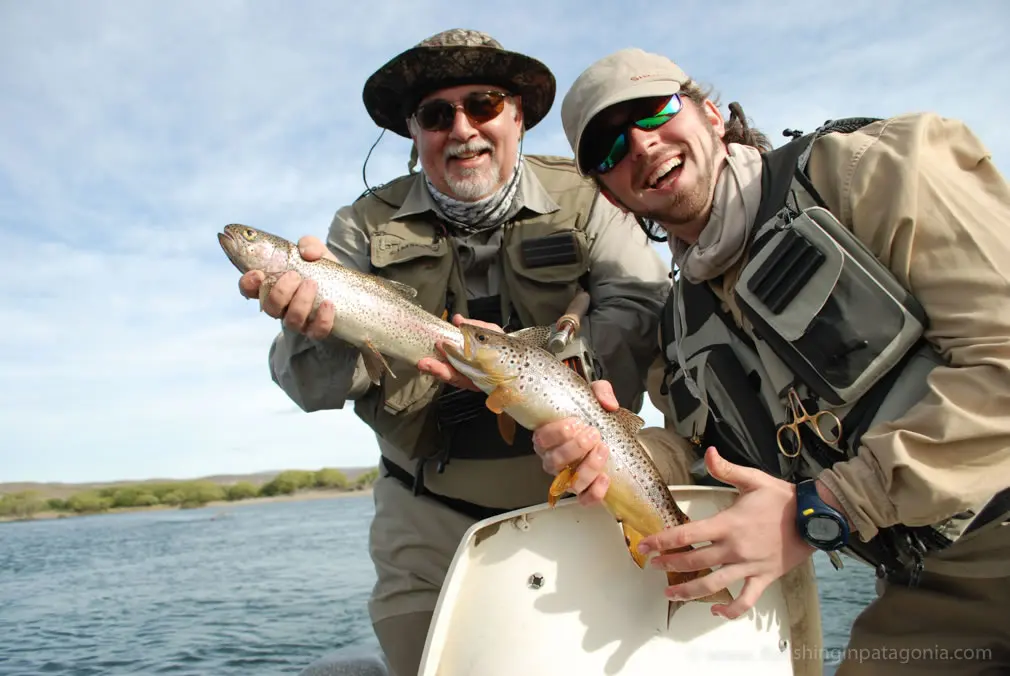 Marce and Tomy with a trout aboard a drift boat on the Collon Cura River