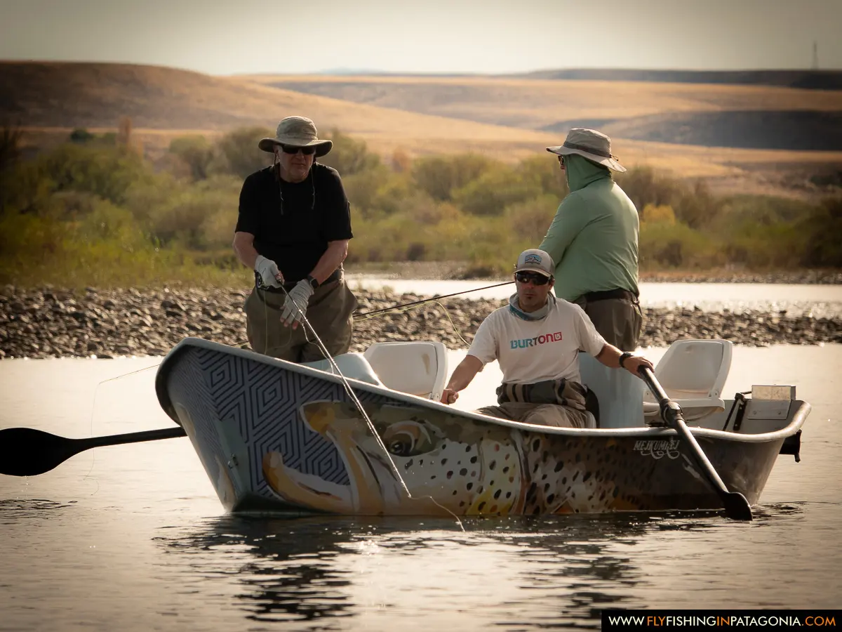 Anglers rowing a painted drift boat on the Collon Cura River