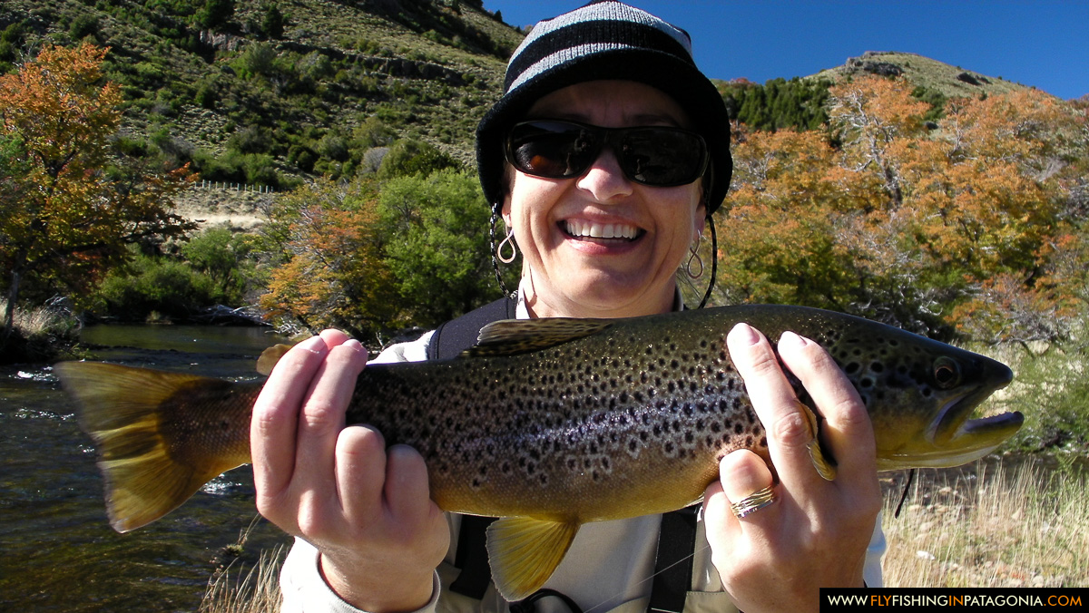 Smiling fly angler holding a large Huaca Mamuil brown trout
