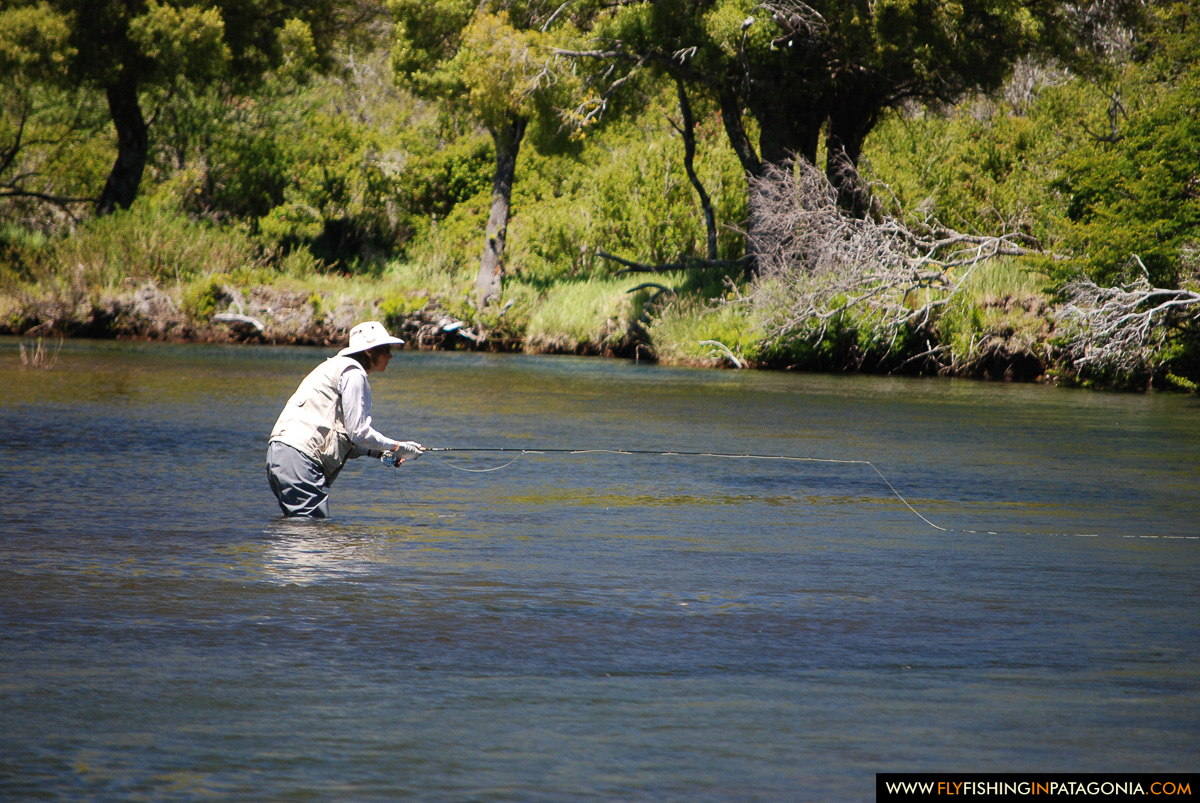 Angler making a fly cast across a wide Huaca Mamuil run