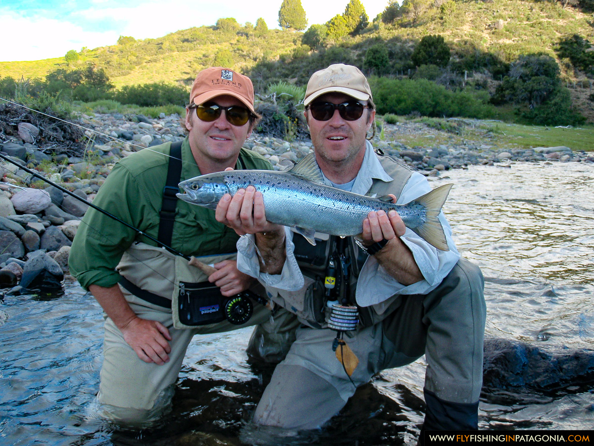 Friends displaying a trout caught on the Traful River