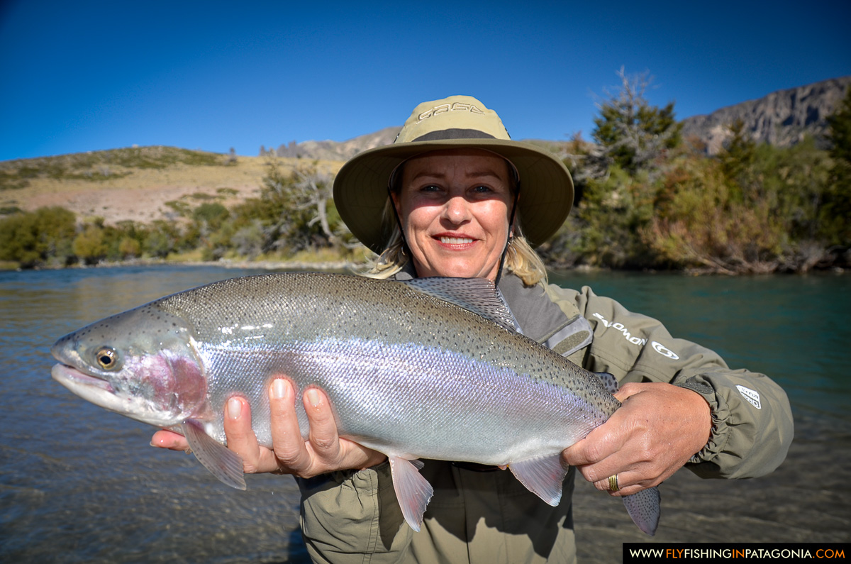Woman holding a wild rainbow trout from the Traful River