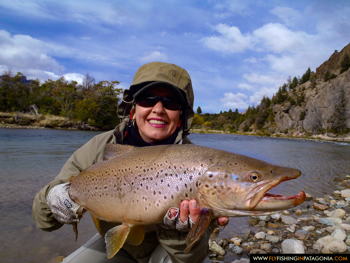 Woman holding a trophy brown trout on the Traful River
